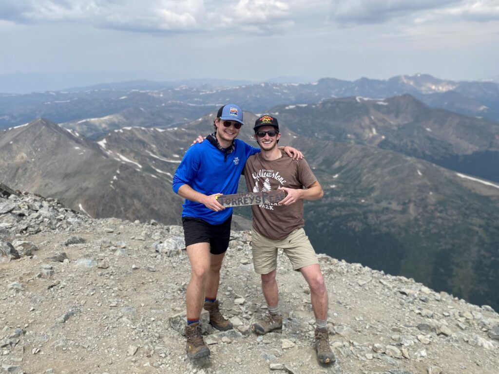 Two people on top of Torreys Peak, a mountain in Colorado